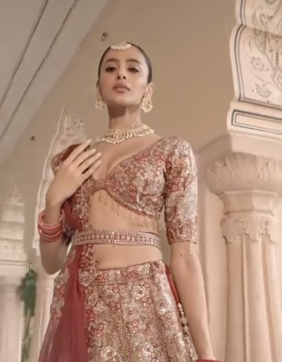 Bride in an embroidered lehenga with kundan jewellery