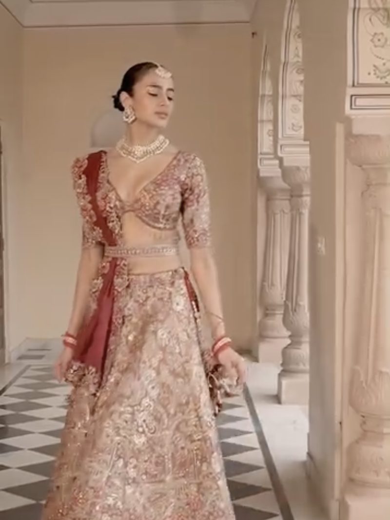 Bride in a rose-gold embroidered bridal lehenga